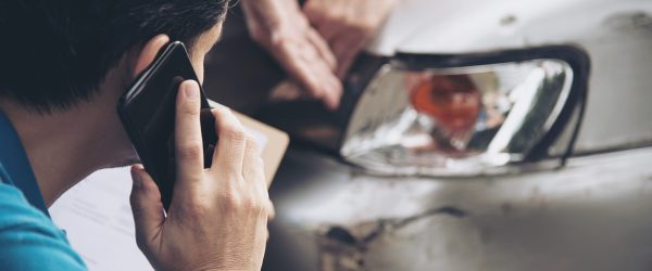 Insurance agent working during on site car accident claim process - people and car insurance claim concept